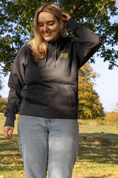 Model wearing Born to Roam LGBTQ hiking hoodie